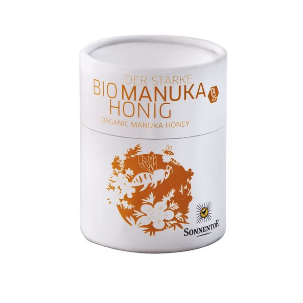 In the photo you can see the package of the strong Manuka honey. On it are many flowers and bees depicted.