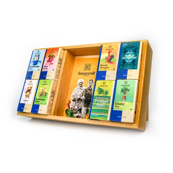 In the photo you can see a wooden tea gastronomy shelf. In it are placed various tea packs.