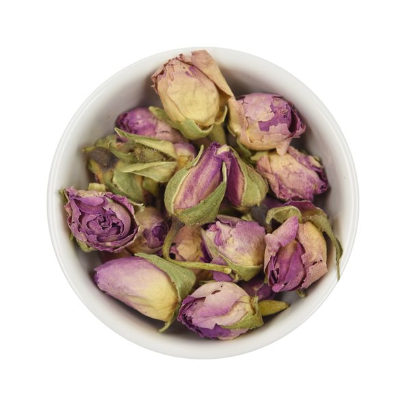 Photo of a small bowl filled with loose rose flowers (buds) from SONNENTOR