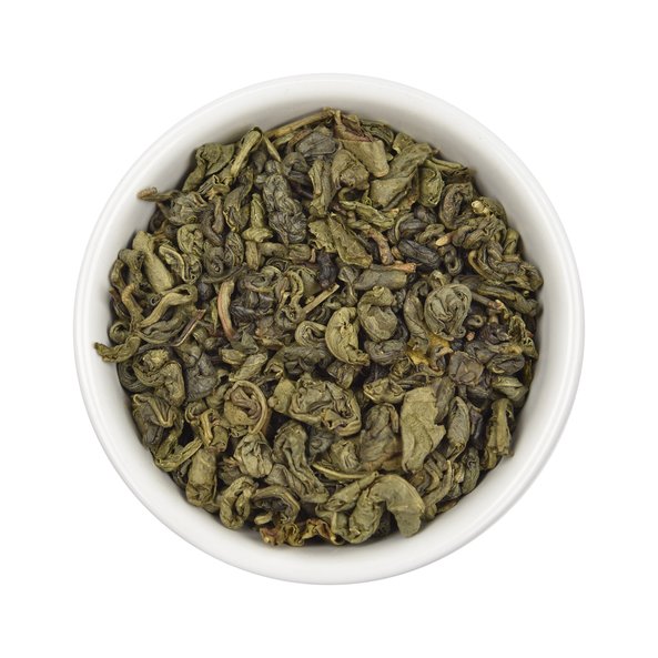 Photo of a small, white bowl filled with SONNENTOR Gunpowder Chinese Green Tea loose