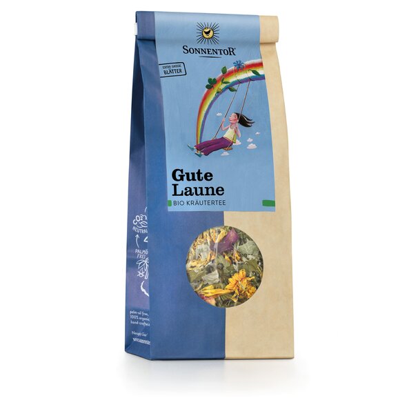 Photo of a pack Cheery Herbal Tea loose. On the package is a picture of a woman sitting and rocking on a swing high in the sky under a rainbow.