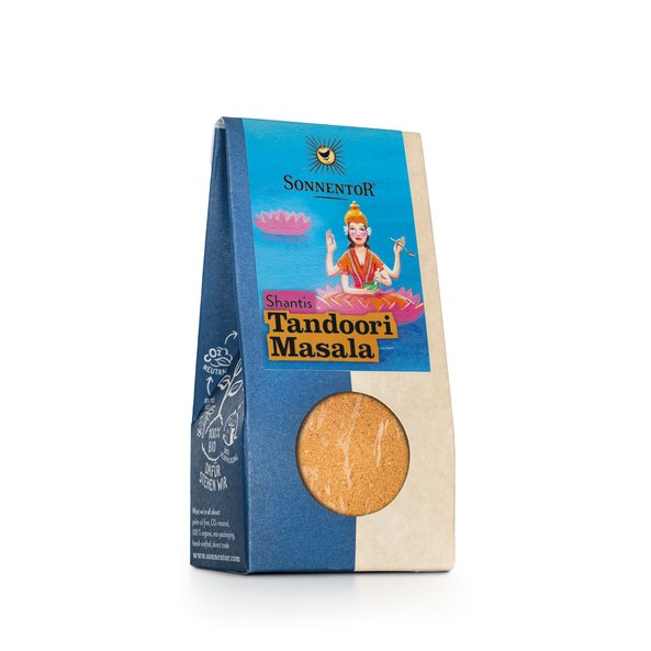 Photo of a pack Shantis Tandoori Masala spice. On the package is a lady with four hands on a lotus flower.