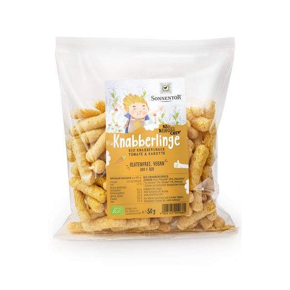 Photo of a transparent pack Knabberlinge snacks. In it you can see the snacks. On the package you can see Bengelchen Leander.