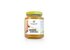 Photo of a jar of honey. On the jar you can see a turmeric root. In the jar is orange honey.