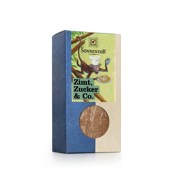 A monkey with a chef's hat on his head and a plate of waffles in one hand and a shaker can in the other is climbing around in a tree and laughing.