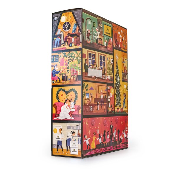 SONNENTOR „Mein großer Adventkalender – Edition 2026“ mit festlich gestaltetem Hausmotiv, weihnachtlichen Fensterszenen und Café.