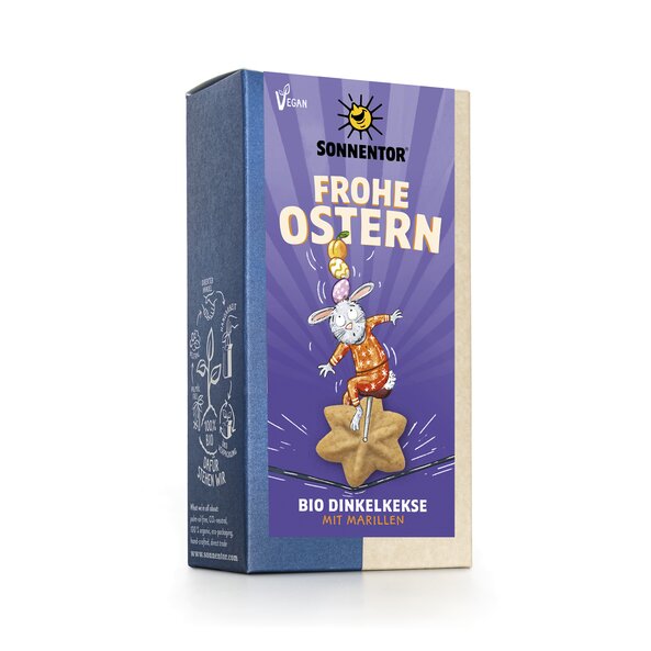 Auf dem Etikett fährt der Osterhase auf einem Osterkeks wie ein Zirkusartist auf einem Einrad auf einem Seil und balanciert dabei Ostereier und eine Marille auf seinem Kopf. 