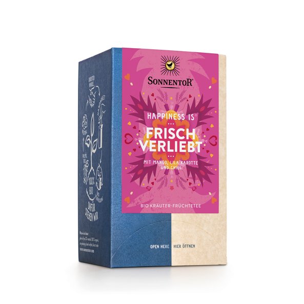 Foto einer Packung Frisch verliebt Tee Bio-Kräuter-Früchteteemischung. Auf der Packung ist eine Illustration mit blumigem Hintergrund in pink mit der Aufschrift Happiness is Frisch verliebt.