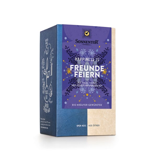 Photo of a pack Celebrating Friendships Tea Organic Herbal Spice Tea Blend. On the package is an illustration with floral background in purple with the inscription Happiness is Celebrating Friendships.