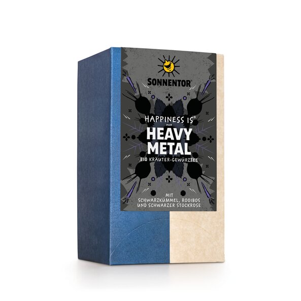 Photo of a pack Heavy Metal Tea Organic Herbal Spice Tea Blend. On the package is an illustration with floral background in grey-black with the inscription Happiness is Heavy Metal.