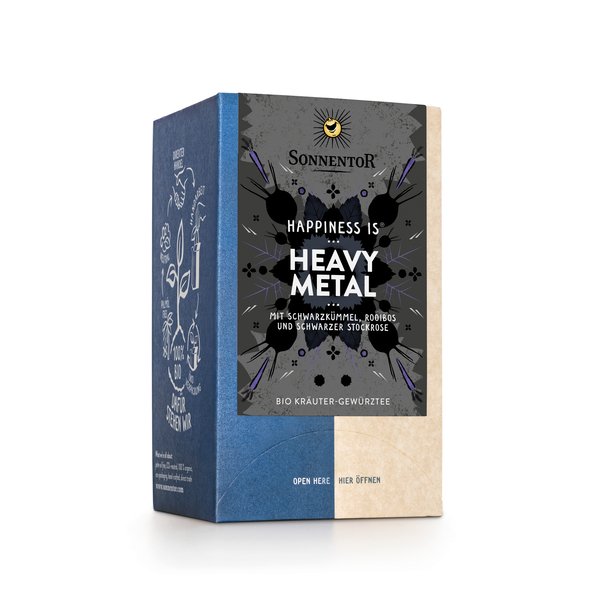 Foto einer Packung Heavy Metal Tee Bio-Kräuter-Gewürzteemischung. Auf der Packung ist eine Illustration mit blumigem Hintergrund in grau-schwarz mit der Aufschrift Happiness is Heavy Metal.