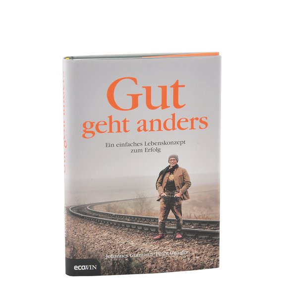 A picture of the book Gut geht anders. The cover shows Johannes Gutmann in the nature in front of train rails.