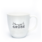 Photo of a white tea cup with the words Sonnige Grüße on it.