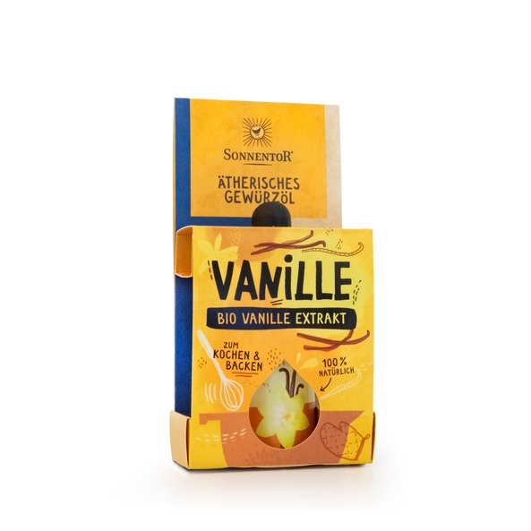 A yellow, orange packaging in which the spice oil can be seen. On the package are a bowl and vanilla beans.
