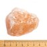 Photo of a pink Ayurvedic salt chunk. Below is a scale, so you can see that the chunk is about six centimeters.