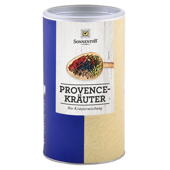 A big jumbo spice tin with herbs à la Provence. On the tin you can see a wooden spoon with colorful spices.